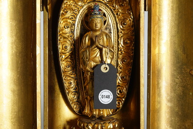 A Japanese lacquered and gilt wood &quot;Zushi&quot; shrine with a standing Buddha on a lotus throne, Edo, 17/18th C.